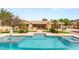 Stunning backyard features a large pool, lush landscaping, and a covered patio area, perfect for outdoor entertaining at 215 Great Gable Dr, Las Vegas, NV 89183