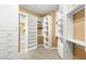 Spacious walk-in closet with custom shelving, drawers, and carpet at 215 Great Gable Dr, Las Vegas, NV 89183