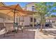 Back patio boasts desert landscaping, a patio set, and an awning for shade, great for relaxing at 2180 Polynesia Cir, Henderson, NV 89074