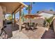 Spacious backyard featuring desert landscaping, a covered patio and dining area for outdoor entertaining at 2180 Polynesia Cir, Henderson, NV 89074
