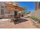 Private patio area featuring desert landscaping, and a shaded dining area, perfect for outdoor gatherings at 2180 Polynesia Cir, Henderson, NV 89074