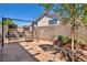 Serene backyard featuring custom hardscape, desert landscaping, and comfortable swing seating for relaxation at 2180 Polynesia Cir, Henderson, NV 89074