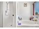 Bright bathroom featuring a separate shower and soaking tub with a window view at 2180 Polynesia Cir, Henderson, NV 89074