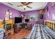 Bedroom featuring hardwood floors, ceiling fan, and sunny window at 2180 Polynesia Cir, Henderson, NV 89074