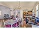 Bright dining area with chandelier and views to the kitchen and living room at 2180 Polynesia Cir, Henderson, NV 89074