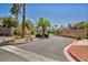 Gated community entrance with lush landscaping and mature trees creating a welcoming ambiance at 2180 Polynesia Cir, Henderson, NV 89074