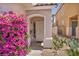 Charming front entrance adorned with vibrant bougainvillea, creating a welcoming curb appeal at 2180 Polynesia Cir, Henderson, NV 89074