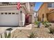 Charming front entrance adorned with vibrant bougainvillea, creating a welcoming curb appeal at 2180 Polynesia Cir, Henderson, NV 89074