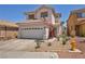 Charming two-story home featuring a well-maintained front yard with xeriscape landscaping at 2180 Polynesia Cir, Henderson, NV 89074