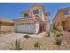 Charming two-story home featuring a well-maintained front yard with xeriscape landscaping at 2180 Polynesia Cir, Henderson, NV 89074