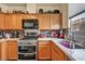 Bright kitchen featuring quartz countertops and stainless-steel appliances at 2180 Polynesia Cir, Henderson, NV 89074