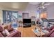 Comfortable living room featuring a fireplace, sliding glass doors, and hardwood floors at 2180 Polynesia Cir, Henderson, NV 89074