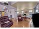 Spacious living room with hardwood floors and adjacent dining and kitchen areas at 2180 Polynesia Cir, Henderson, NV 89074