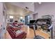 Spacious living room featuring hardwood floors, fireplace, and dining area at 2180 Polynesia Cir, Henderson, NV 89074