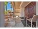 Covered patio with outdoor seating and a view of the private backyard at 2180 Polynesia Cir, Henderson, NV 89074