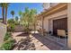 Outdoor patio space with covered area, seating, mature trees, and landscaped garden at 2180 Polynesia Cir, Henderson, NV 89074