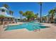A stunning community pool with lounge seating and lush landscaping under a clear blue sky, perfect for relaxation and recreation at 2180 Polynesia Cir, Henderson, NV 89074
