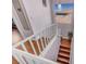Bright stairwell with white railing, pendant lighting, and hardwood steps at 2180 Polynesia Cir, Henderson, NV 89074