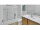 Clean bathroom featuring a shower with glass doors, a single sink, and white fixtures at 2485 Jade Sky St, Henderson, NV 89044