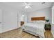 Bright bedroom boasts wood floors, ceiling fan and an ensuite bathroom at 2485 Jade Sky St, Henderson, NV 89044