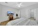Bedroom with wood floors, ceiling fan, and tv at 2485 Jade Sky St, Henderson, NV 89044