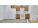 Spacious kitchen with oak cabinets, white appliances, and tile flooring at 2485 Jade Sky St, Henderson, NV 89044