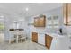Open kitchen with oak cabinets, white appliances, and a view of the living room at 2485 Jade Sky St, Henderson, NV 89044