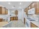 Well-equipped kitchen featuring oak cabinets, white appliances, and tile flooring at 2485 Jade Sky St, Henderson, NV 89044