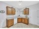 Well-maintained kitchen with oak cabinets, white appliances, and tile flooring at 2485 Jade Sky St, Henderson, NV 89044