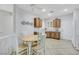 Bright kitchen and dining area featuring oak cabinets, neutral countertops, and tile flooring at 2485 Jade Sky St, Henderson, NV 89044