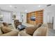 Open living room with tile floors, built-in shelving, and seamless transition to the kitchen and dining area at 2485 Jade Sky St, Henderson, NV 89044