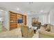 Cozy living room with neutral tones, a ceiling fan, and built-in shelving for organized living at 2485 Jade Sky St, Henderson, NV 89044
