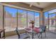 Relaxing screened-in patio featuring outdoor seating and a view of the landscaped backyard at 2485 Jade Sky St, Henderson, NV 89044