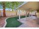 Spacious covered back patio with built in countertop, artificial turf, and ceiling fans at 249 Gentle Springs Dr, Henderson, NV 89012