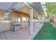 Covered back patio with a built-in grill, a ceiling fan, and artificial turf at 249 Gentle Springs Dr, Henderson, NV 89012