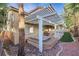 A pergola covers a spa and patio with artificial turf in the backyard at 249 Gentle Springs Dr, Henderson, NV 89012