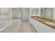 Bathroom featuring double sinks, soaking tub, and glass-enclosed shower at 249 Gentle Springs Dr, Henderson, NV 89012