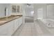Bathroom featuring double sinks, soaking tub, and shower stall at 249 Gentle Springs Dr, Henderson, NV 89012