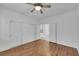 Bright bedroom featuring wood floors, ceiling fan, and double-door closet at 249 Gentle Springs Dr, Henderson, NV 89012