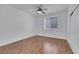 Inviting bedroom features laminate wood flooring, large window, and ceiling fan at 249 Gentle Springs Dr, Henderson, NV 89012