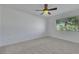 Bright carpeted bedroom with ceiling fan and large window views at 249 Gentle Springs Dr, Henderson, NV 89012