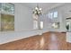 Elegant dining room with hardwood floors, high ceilings, large windows, and a stylish chandelier at 249 Gentle Springs Dr, Henderson, NV 89012