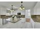 Updated kitchen featuring granite countertops, stainless steel appliances, a center island, and white cabinetry at 249 Gentle Springs Dr, Henderson, NV 89012