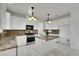 Modern kitchen featuring granite countertops, stainless steel appliances, and a functional center island at 249 Gentle Springs Dr, Henderson, NV 89012