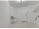 Functional laundry room featuring tile flooring, storage shelf and a chair at 249 Gentle Springs Dr, Henderson, NV 89012