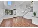 Bright living room with hardwood floors, large windows, and a grand staircase at 249 Gentle Springs Dr, Henderson, NV 89012