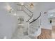 Elegant curved staircase with white railings and modern lighting fixtures at 249 Gentle Springs Dr, Henderson, NV 89012