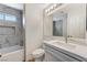 Modern bathroom with marble tile, a bathtub, and a stylish vanity at 2633 S Durango Dr # 201, Las Vegas, NV 89117