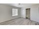 Bedroom boasts an open closet with sliding doors, interior shelving, and a window at 2633 S Durango Dr # 201, Las Vegas, NV 89117
