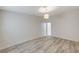 This cozy bedroom is bright with neutral walls, gray-toned flooring, and an open doorway at 2633 S Durango Dr # 201, Las Vegas, NV 89117